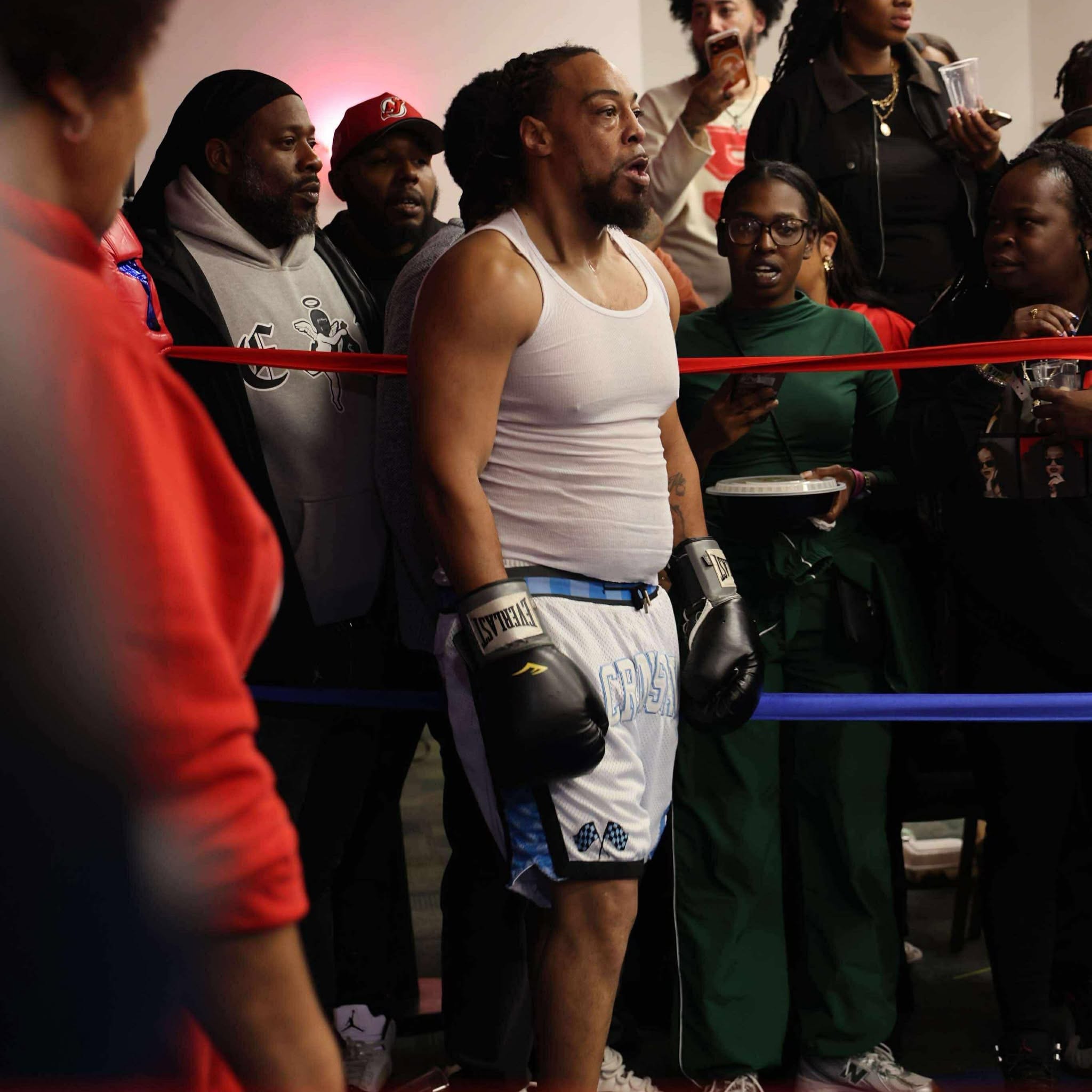 Taron Streets inside the boxing ring with gloves and crowd